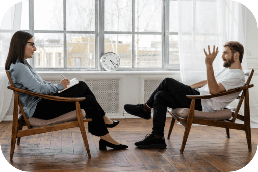 Deux personnes : un patient et un psychologue en séance de TCC en cabinet